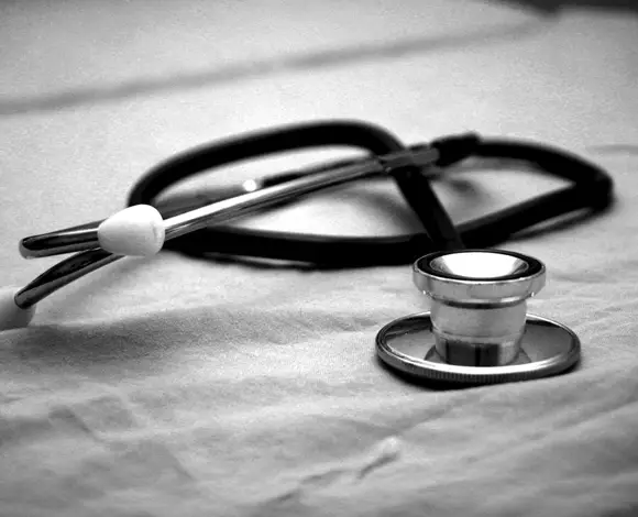 Stethescope on bed, indicative of health care